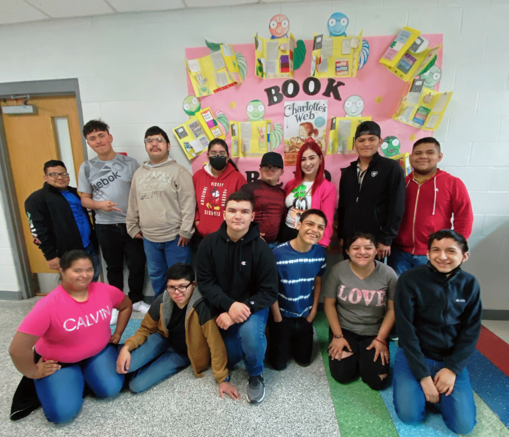 JLHS Students with teacher posing in front of Charlotte's Web Book Reports