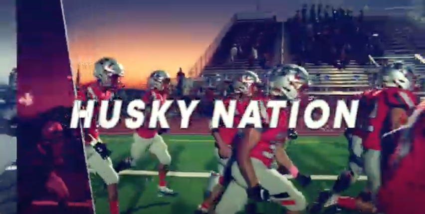 Husky nation text in front of football players running on field