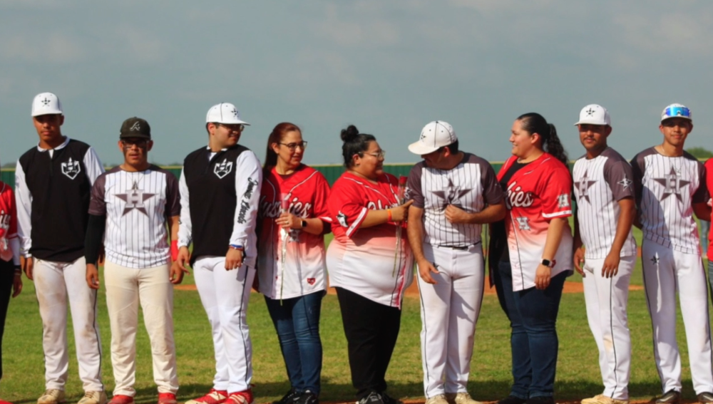 teachers in jerseys on baseball field with JLHS baseball seniors