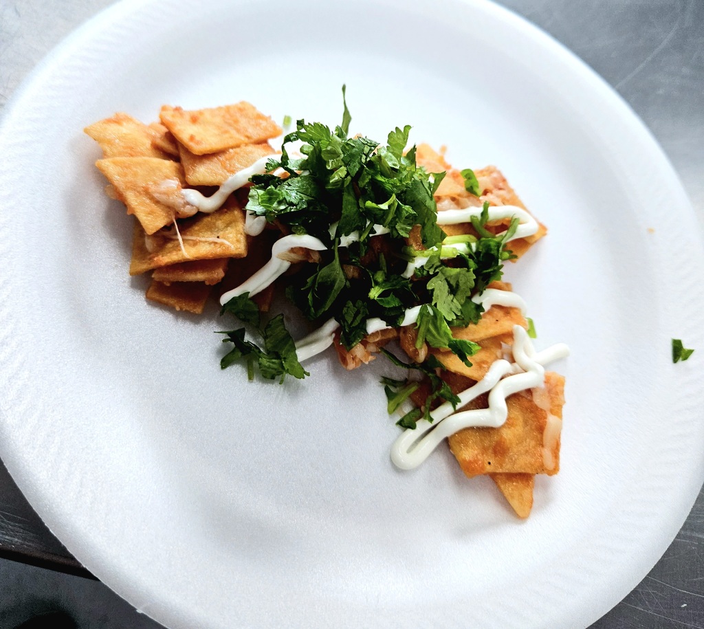 chilaquiles topped with sour cream and cilantro