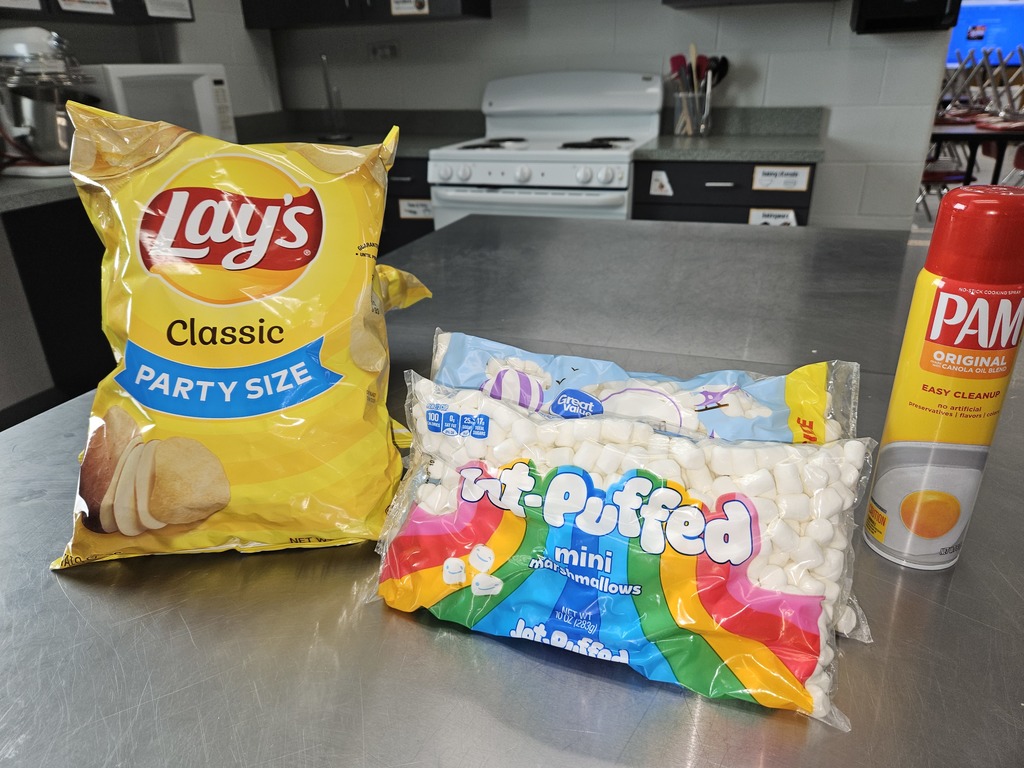 bag of potato chips, bag of marshmallows, and spray oil on cooking table