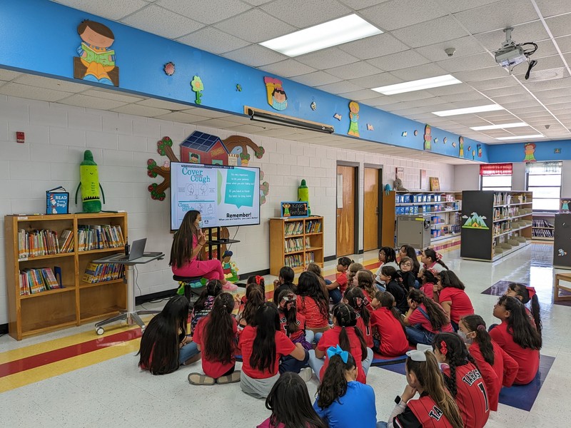 Nurse A. Castro helps students learn techniques for self care and hygiene. 